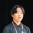 Portrait of Toma Okugawa speaking on stage